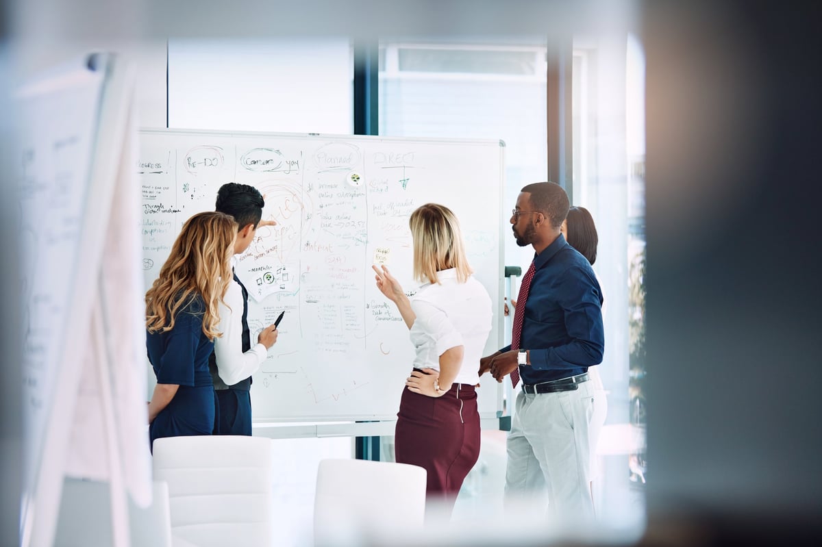 Cropped shot of a group of businesspeople working together in the office