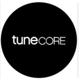 TuneCore logo - white text on black circular background