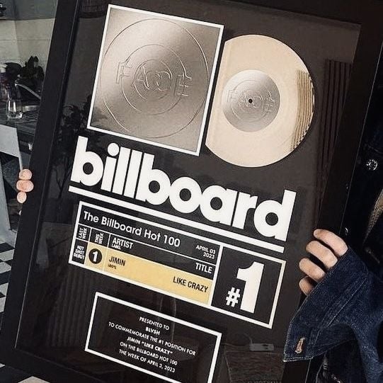Framed Billboard Hot 100 number one platinum record award with gold and silver vinyl displayed